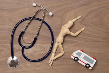 倒れた人と救急車と聴診器