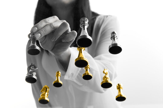 Businesswoman moving golden chess piece forward among competitors. Concept of startup leadership, founder mindset, competitive advantage, bold decisions, business growth strategy.