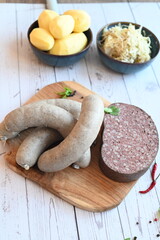 traditional Czech pork sausages and blood pudding served as classic slaughterhouse specialties, Masopust cuisine, butcher products presented on a light background, authentic regional food concept,