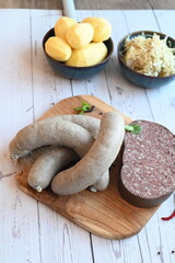 traditional Czech pork sausages and blood pudding served as classic slaughterhouse specialties, Masopust cuisine, butcher products presented on a light background, authentic regional food concept,