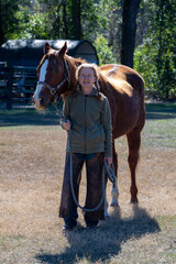 A woman walking her quarter horse in Florida