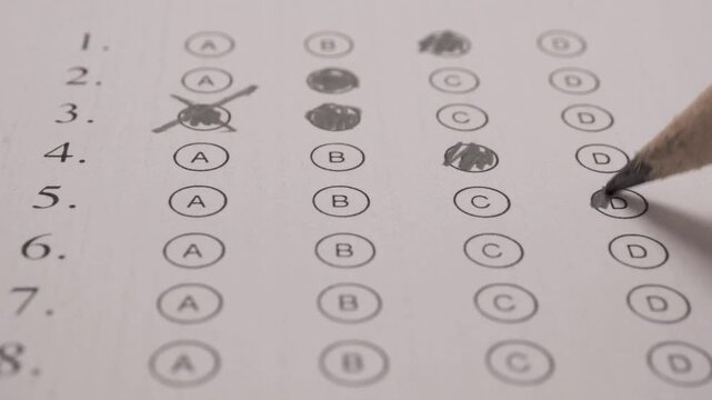 close up shot multiple choice exam filling with pencil macro.