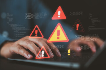 Cybersecurity warning concept with alert icons and code on a laptop screen, showing a businessman facing system errors, malware threats, hacking risks, or data breaches during development.