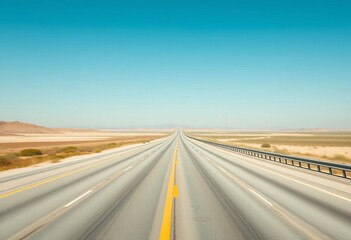 Fototapeta premium Empty highway stretches to horizon under clear sky, trees, asphalt