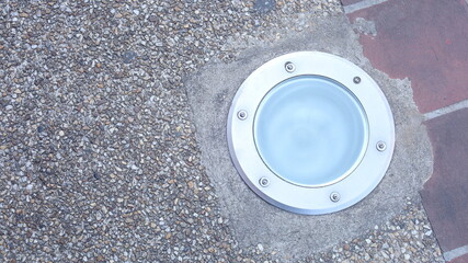 Ground Lamp. Modern style old style ground lamp, round LED sidewalk light with copy space with selective focus.
