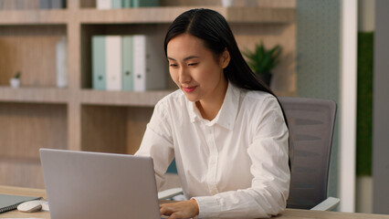 Dreaming brainstorming Asian Japanese business woman female office worker Chinese Korean businesswoman manager entrepreneur thinking ponder idea raise finger startup project work typing laptop indoor