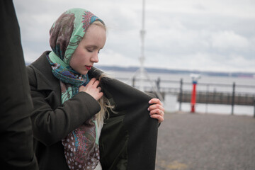 Young woman in season coat posing outdoors