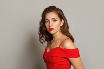 Perfect woman with long hair and make-up on white background. Gorgeous woman with curly hairstyle