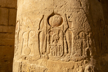 Hieroglyphic carvings on an ancient column in a historic Egyptian temple during daylight hours, Luxor Temple