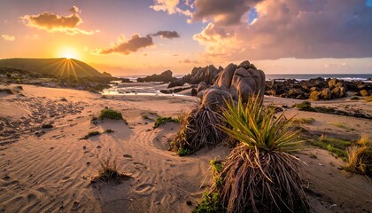 Dramatic Sunset Over Rugged Coastal Landscape with Sandy Beach and Rocky Outcrops.