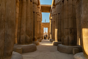 exploration ancient columns in Luxor Temple during midday sun in Egypt