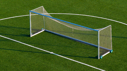 Aerial view of small football goal placed on artificial turf training pitch