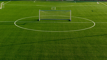Wide view of football training field with artificial turf and single goal