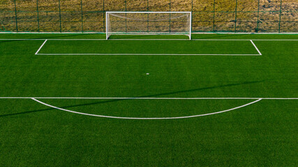 Football goal on artificial turf pitch with visible penalty area lines
