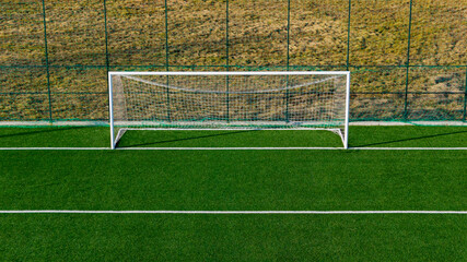 Front view of football goal on empty artificial turf training field