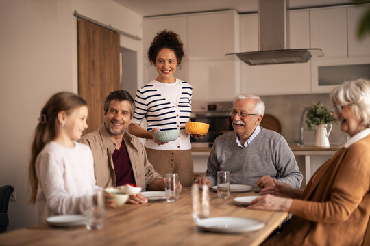 Multi-generational family enjoying a joyful kitchen lunch together