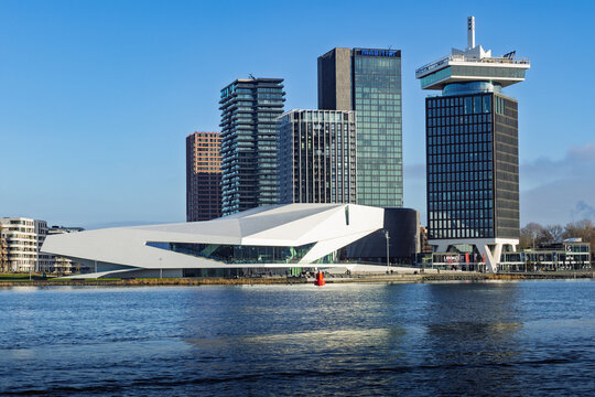 Modern skyline of Amsterdam North featuring the white futuristic Eye Filmmuseum and the tall A'DAM Lookout tower along the river IJ on a sunny day. Amsterdam Netherlands, 28 december 2025