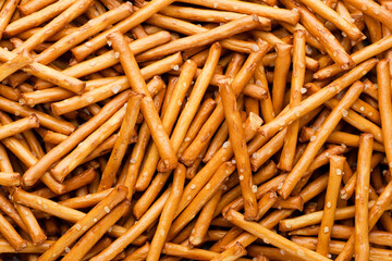 Pretzel sticks with salt background. Top view