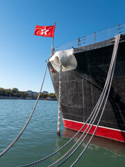 Mooring rope tied to a pier on the shore. Ship rope fastened to the dock in a mushroom shape