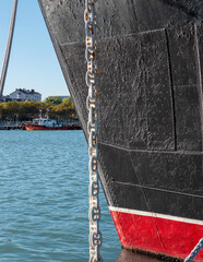 Mooring rope tied to a pier on the shore. Ship rope fastened to the dock in a mushroom shape