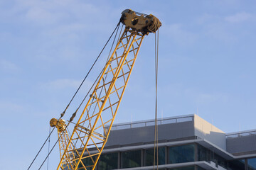 Close-up of the arm of a large construction crane in the morning light.