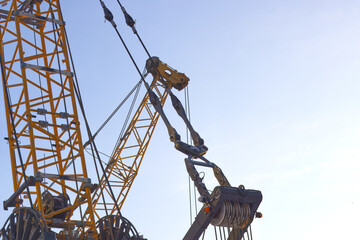 Close-up of the arm of a large construction crane in the morning light.