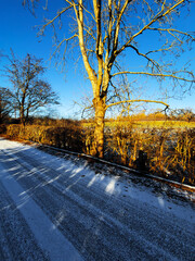 country rural road covered with ice snow and frost