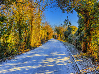 country rural road covered with ice snow and frost
