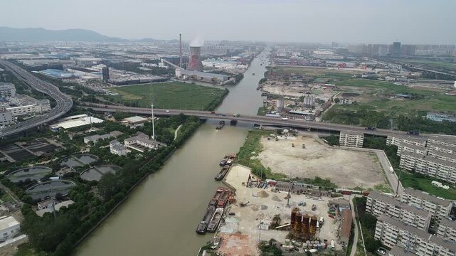 Drone flight over busy stretch of the historic Grand Canal in Suzhou, transportation and infrastructure in China
