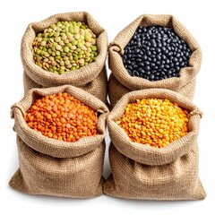 Four burlap sacks overflowing with different colorful dried pulses