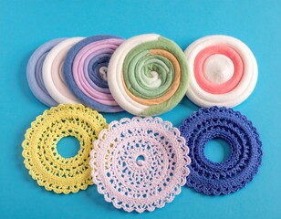 Colorful coasters and decorative circles displayed on a blue surface