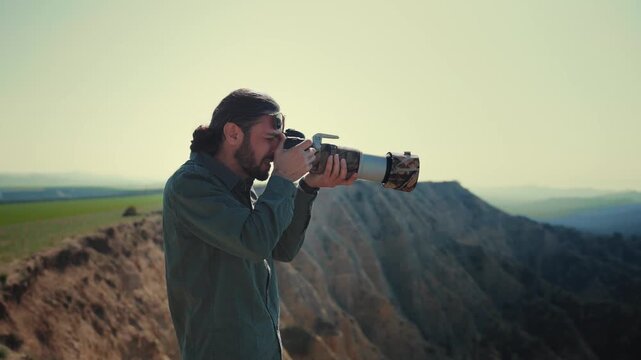 Professional wildlife photographer photographing wild animals in a vast desert landscape during golden hour. Documentary-style nature photography capturing conservation, exploration, adventure, and th