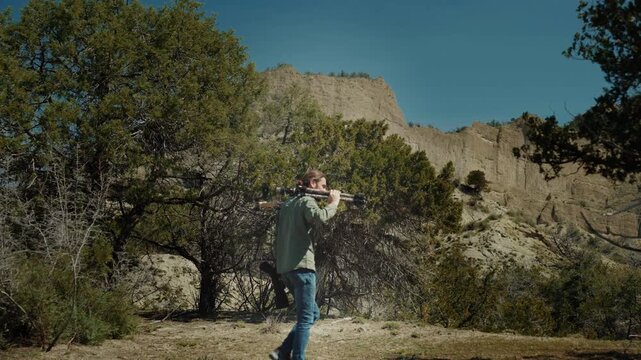 Professional wildlife photographer photographing wild animals in a vast desert landscape during golden hour. Documentary-style nature photography capturing conservation, exploration, adventure, and th - Powered by Adobe