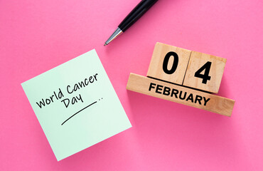 World cancer day reminder on sticky note and calendar