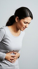 Young Woman Suffering from Severe Abdominal or Stomach Pain
