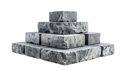 Pyramid-shaped stack of gray, rectangular stone blocks against a solid black background