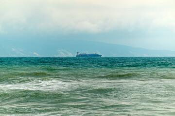 August 24, 2025: Large cargo ship entering the port of Novorossiysk, Russia, on the Black Sea, illustrating maritime transport, industrial shipping and coastal infrastructure