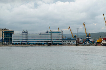 Obraz premium August 22 2025 Building of Novorossiysk Commercial Sea Port in Novorossiysk Russia on the Black Sea coast. Administrative port building and maritime infrastructure