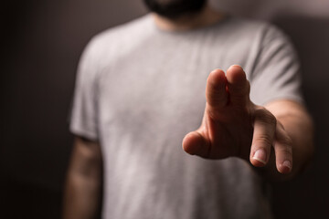 Close up of a man reaching out his finger to touch or interact with something.  Concept of interaction,  touch,