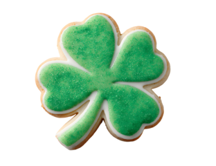 A beautifully decorated green four leaf clover sugar cookie against a solid black background