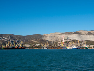 August 22 2025 View of Novorossiysk port Russia with cargo ships and cranes on the coastline. Industrial maritime scene on the Black Sea