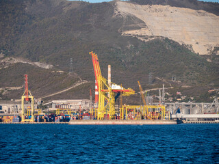 August 22 2025 View of Novorossiysk port Russia with cargo ships and cranes on the coastline. Industrial maritime scene on the Black Sea