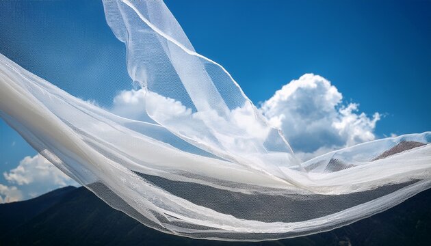 light tulle fabric floating under the blue sky