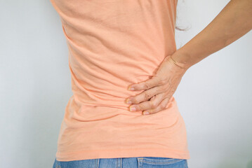 Woman suffering from backache on white background. Health care and medical concept.