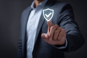 Male businessman touching digital shield icon for cybersecurity and data protection