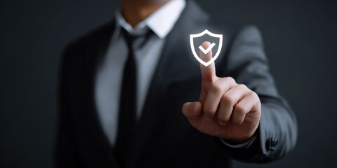 Businessman activating security shield icon on virtual interface