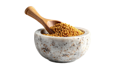 Close-up of a small, speckled stone bowl overflowing with tiny, golden seeds, a wooden scoop nestled inside