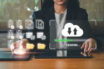 Businesswoman interacts with digital tablet, showcasing cloud computing and data synchronization in a modern office environment.