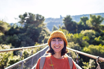 stylish young woman with a backpack travels in sunny weather. Happy female tourist enjoying her trip. Girl with a backpack.