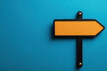 Yellow Arrow Sign on Blue Background for Direction and Navigation Concept.